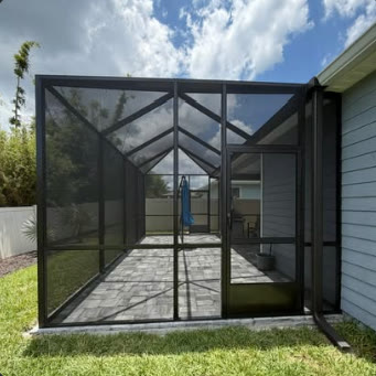 Gable end of a finished screen enclosure beside a house