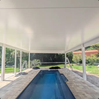 White aluminium patio cover over a pool deck on white posts