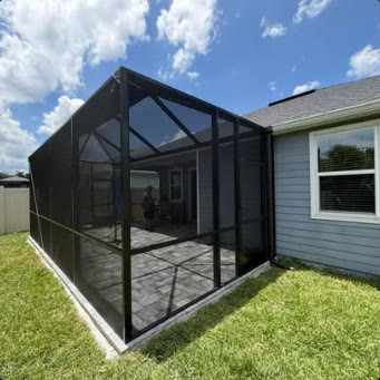 Dark aluminium screen enclosure built onto the rear of a house